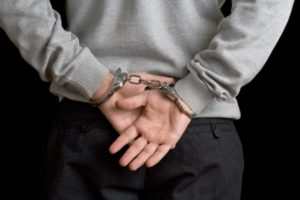 Image of a man in handcuffs after accidentally committing a crime.